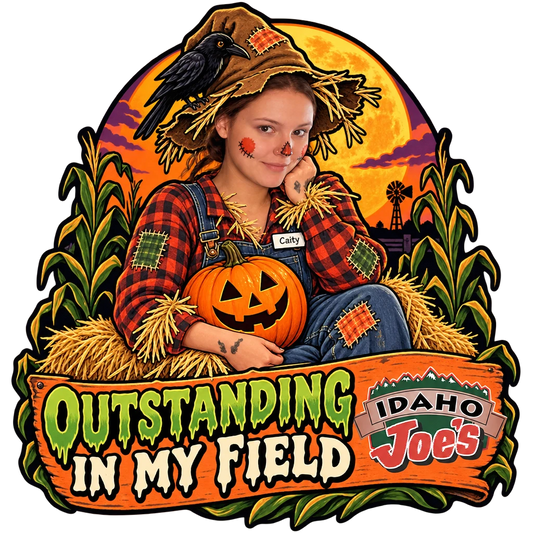 Idaho Joe's sticker: Caity dressed as a scarecrow in a corn field – “Outstanding in My Field”